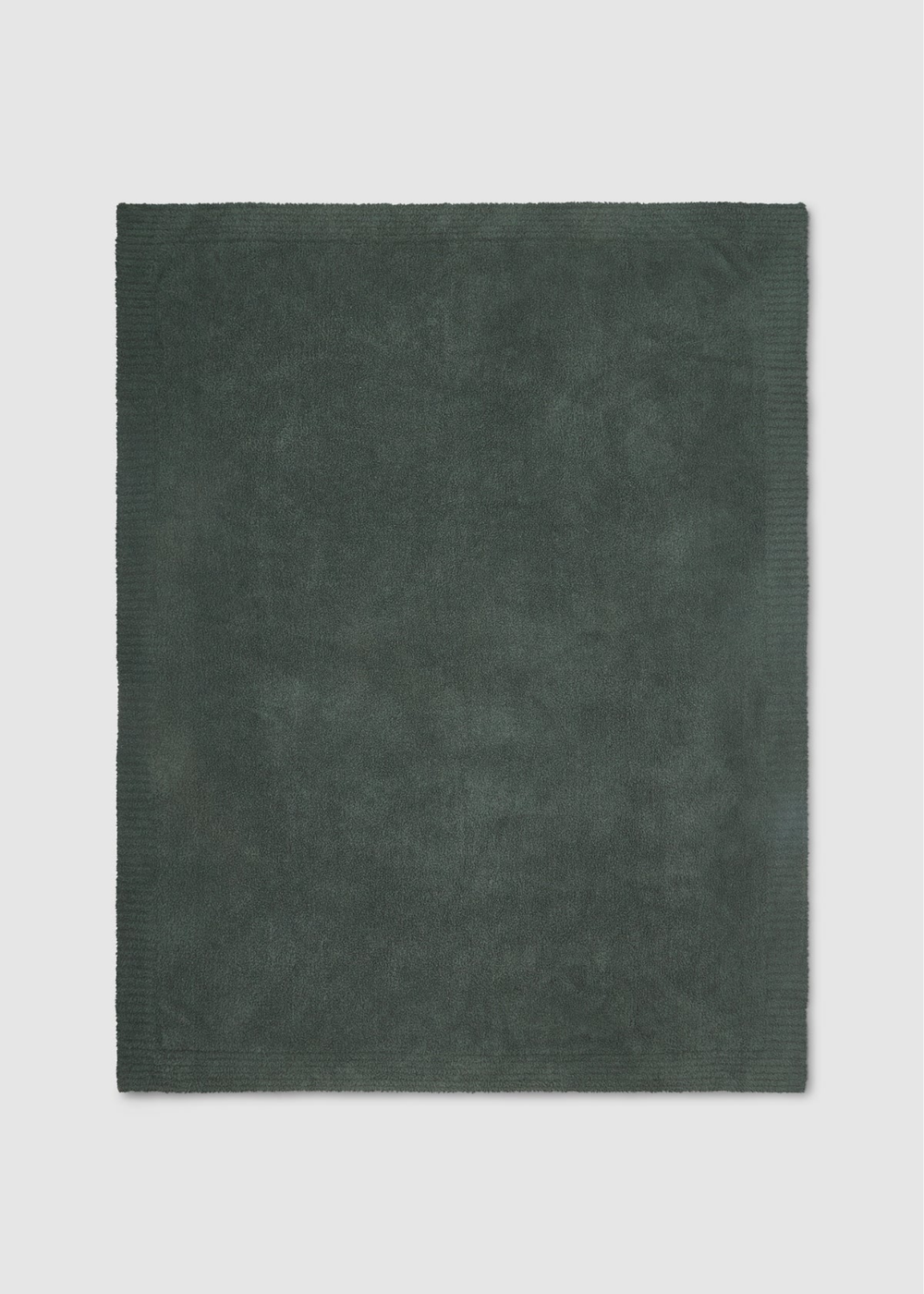 A dark green rectangular bath blanket with a ribbed border, laid flat against a light gray background.