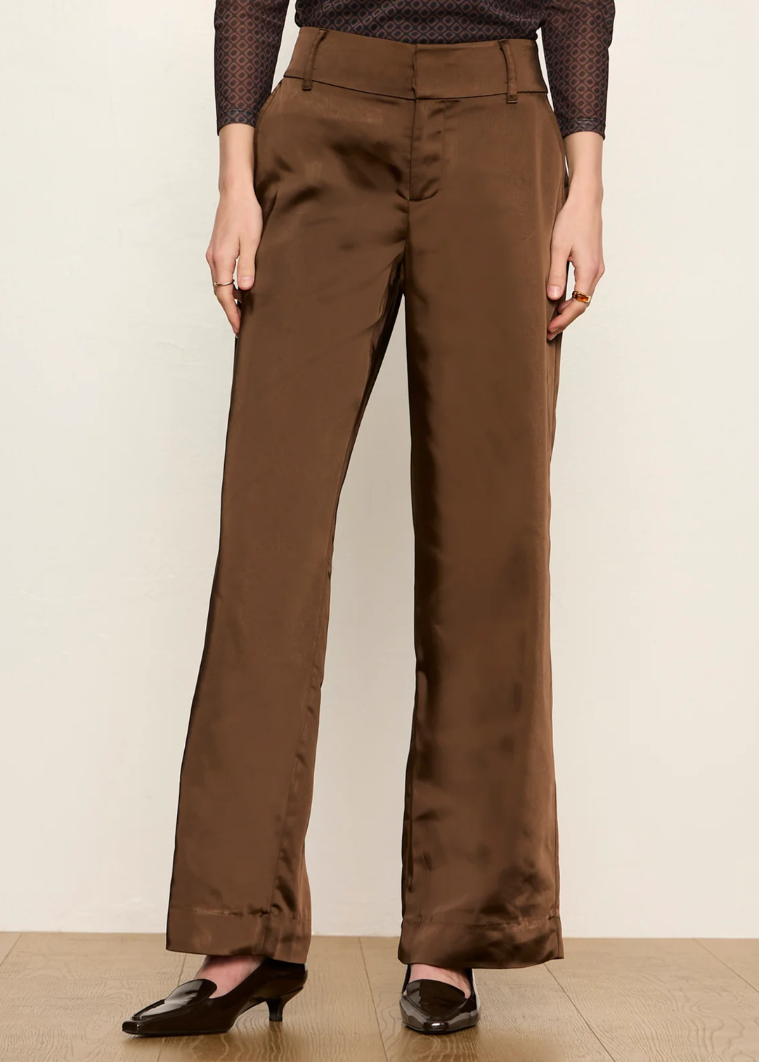 Woman wearing brown dress pant and kitten heel.
