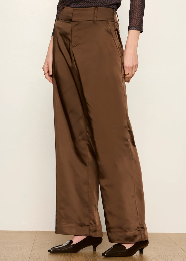 Woman wearing brown dress pant and kitten heel.
