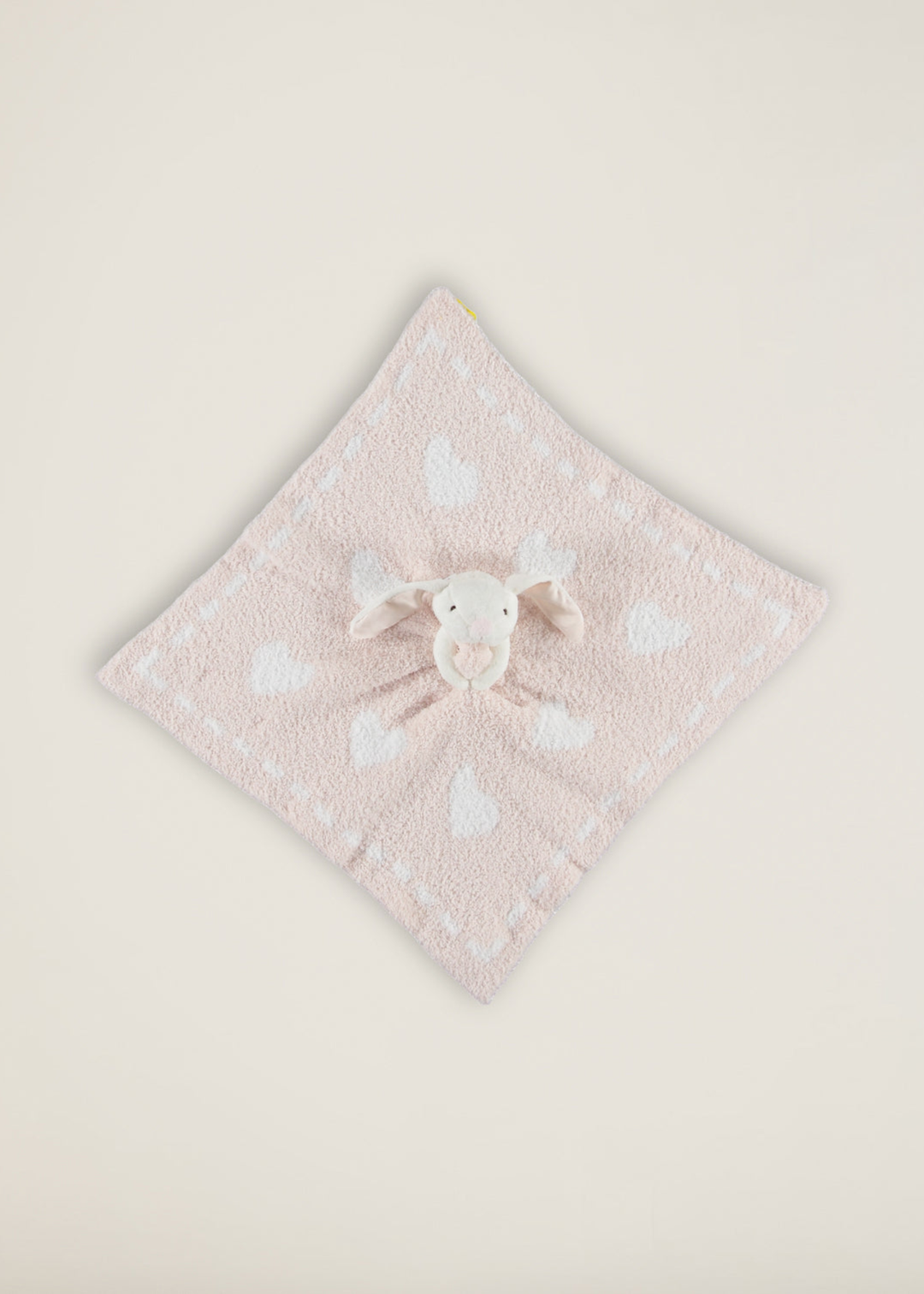 Stuffed bunny with a pink baby blanket with hearts attached