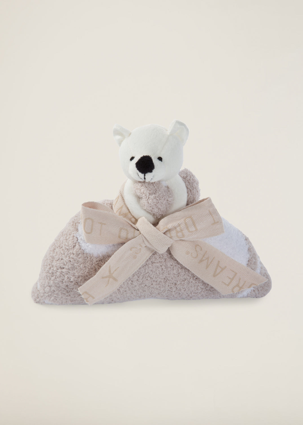 Stuffed animal attached to a brown blanket