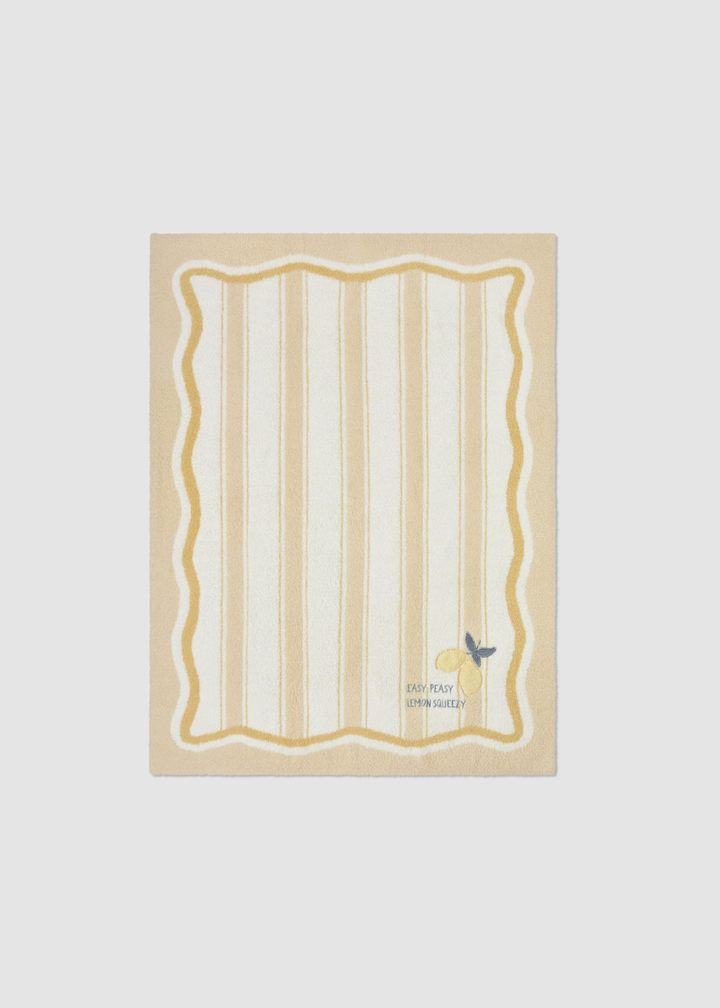 Yellow baby blanket with a striped pattern and lemon embroidery and lettering