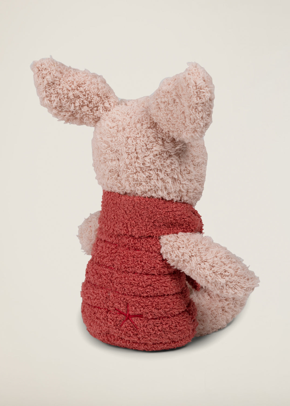 A pink piglet stuffed animal turned around