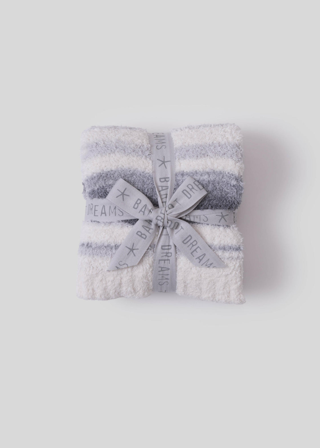 Blue and cream striped blanket folded with a grey bow on a white background