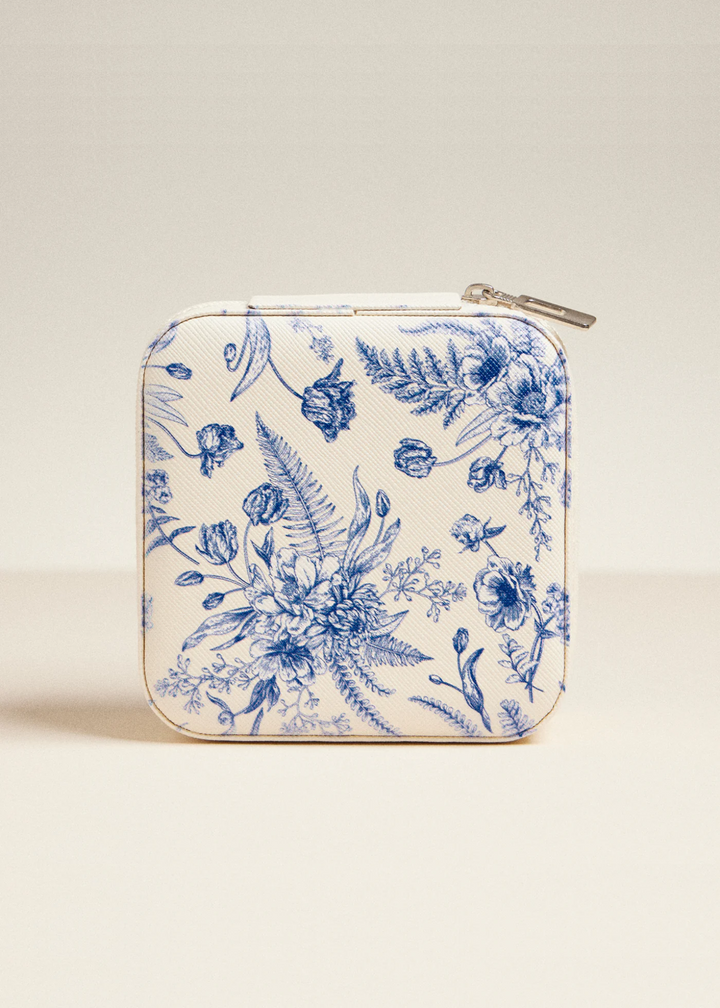 White travel jewelry box with a navy floral print on a white background