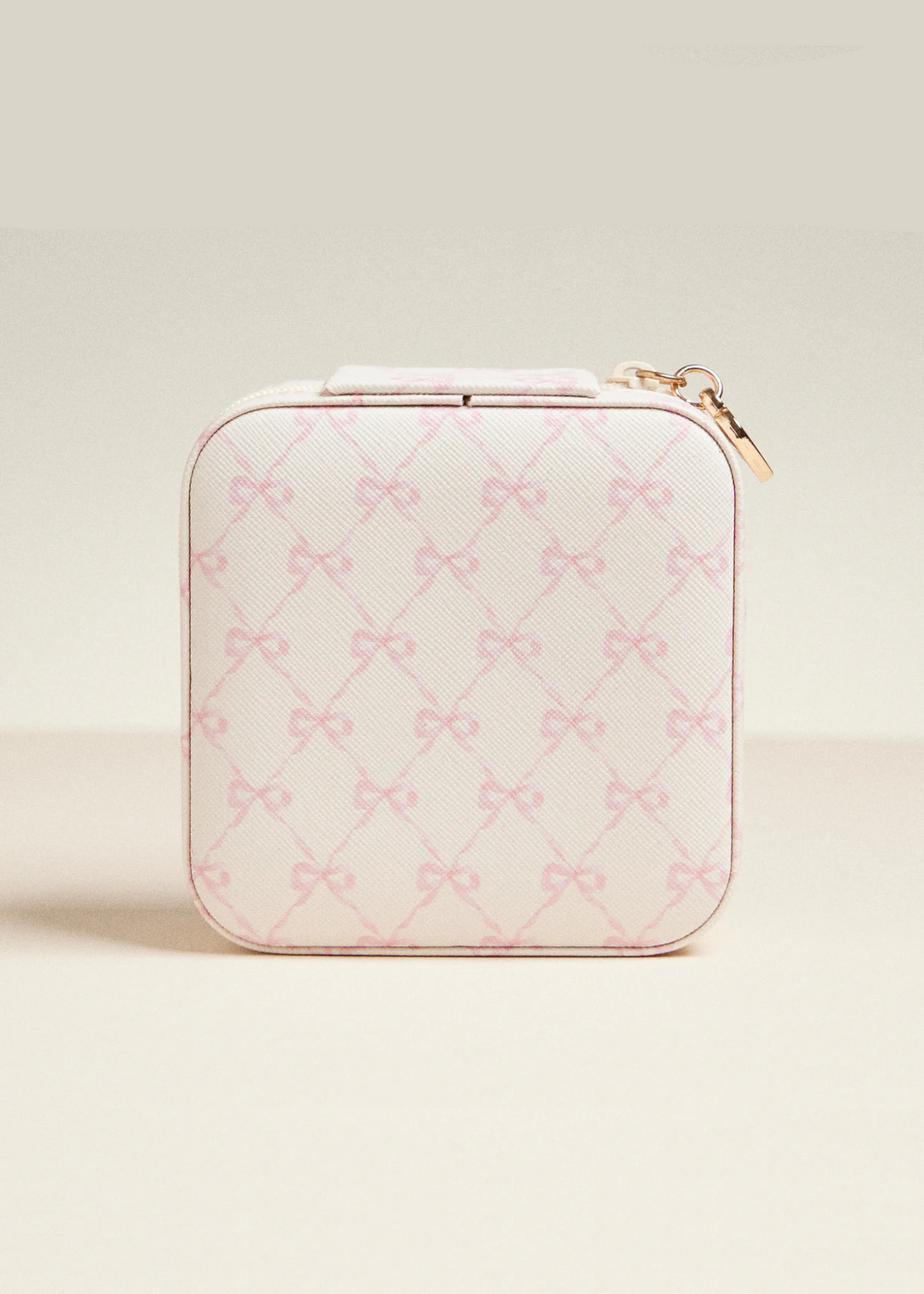 White travel jewelry box with a pink bow pattern on a white background