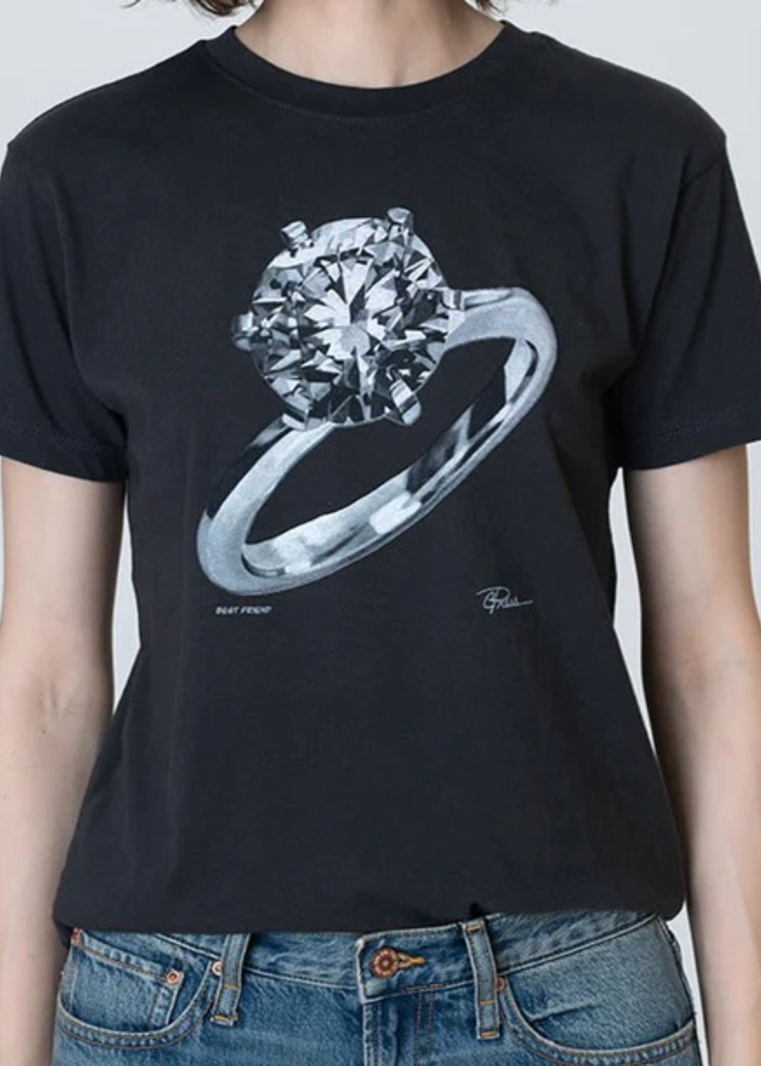 Woman wearing a black tee with an engagement ring graphic