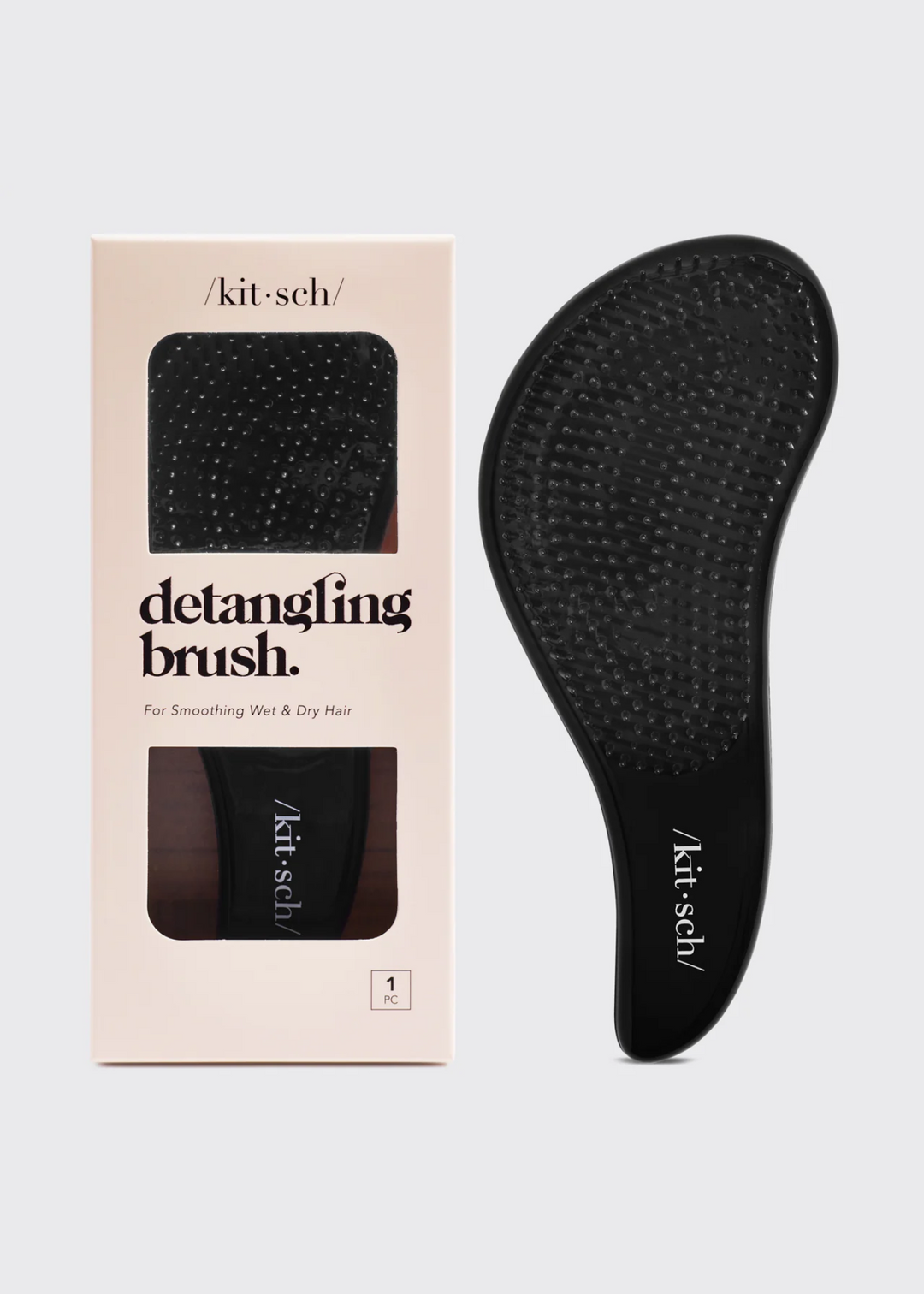 Black detangling brush on a white background