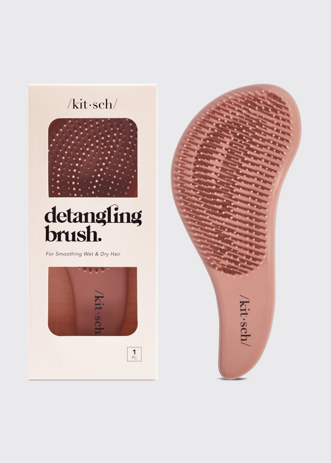 Women's pink detangling brush on a white background