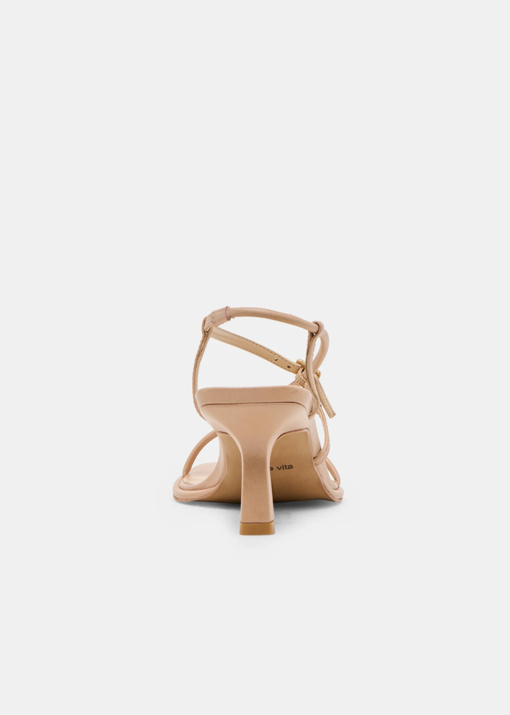 Back view of tan strappy heels with a gold button against a white background