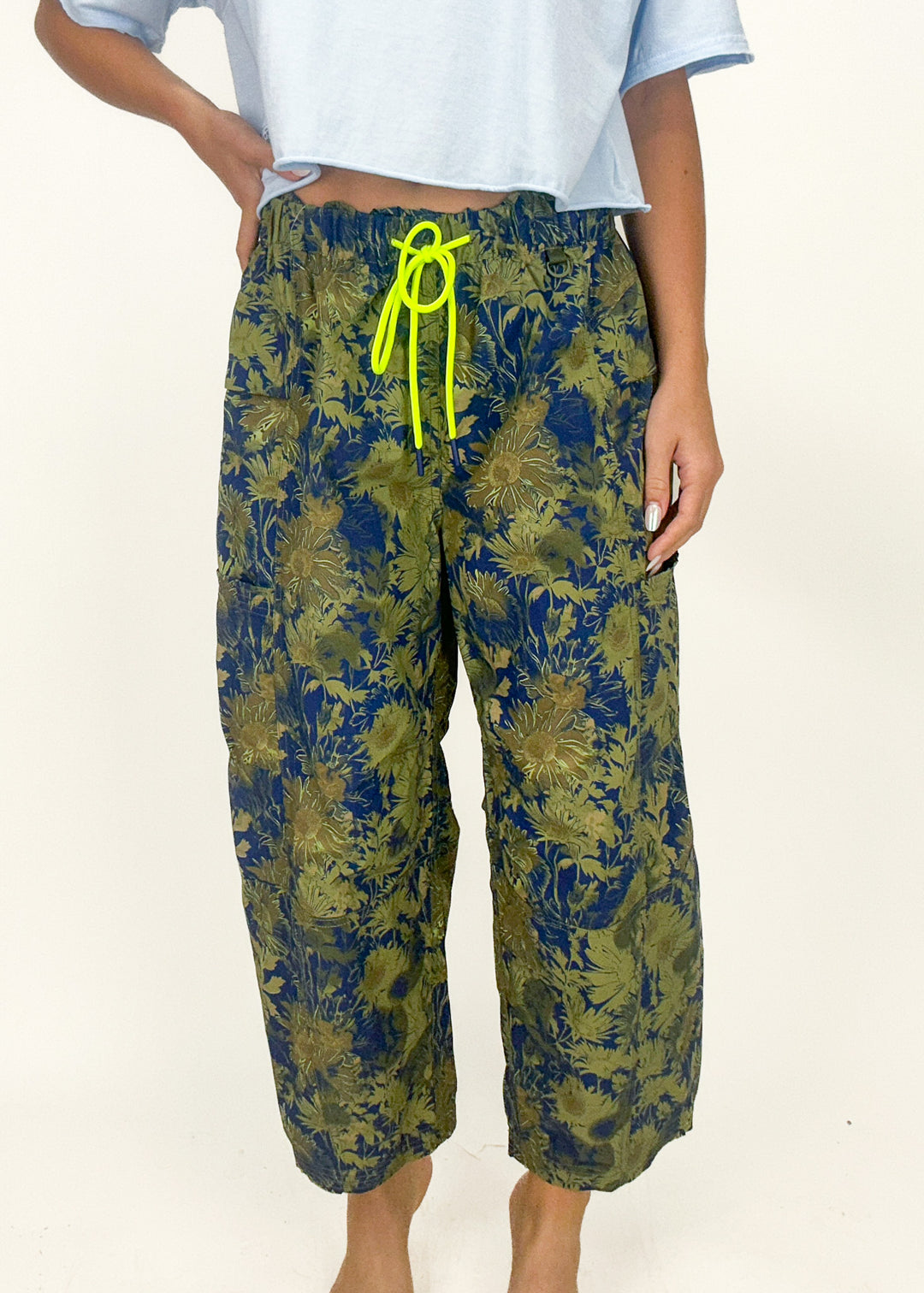 blue and green floral camo barrel leg pants with neon green drawstring at waist