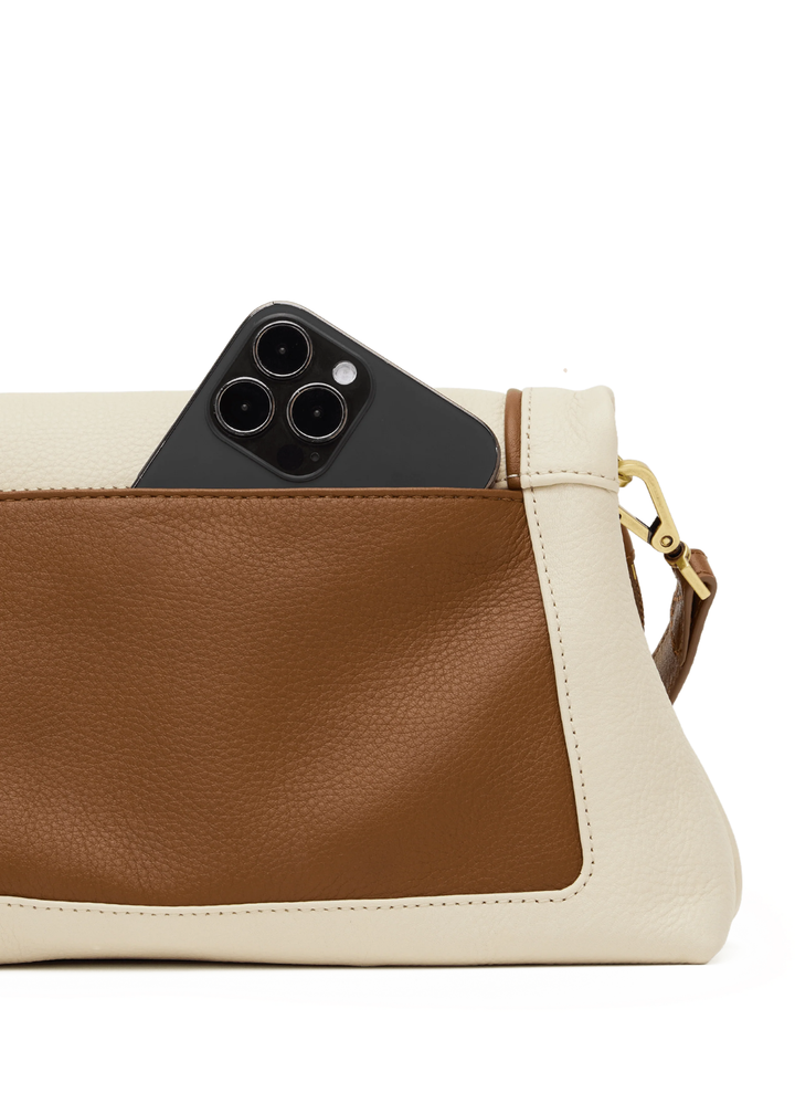 White leather purse with brown trim and gold accents