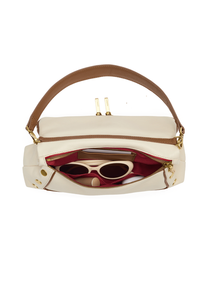 White leather purse with brown trim and gold accents
