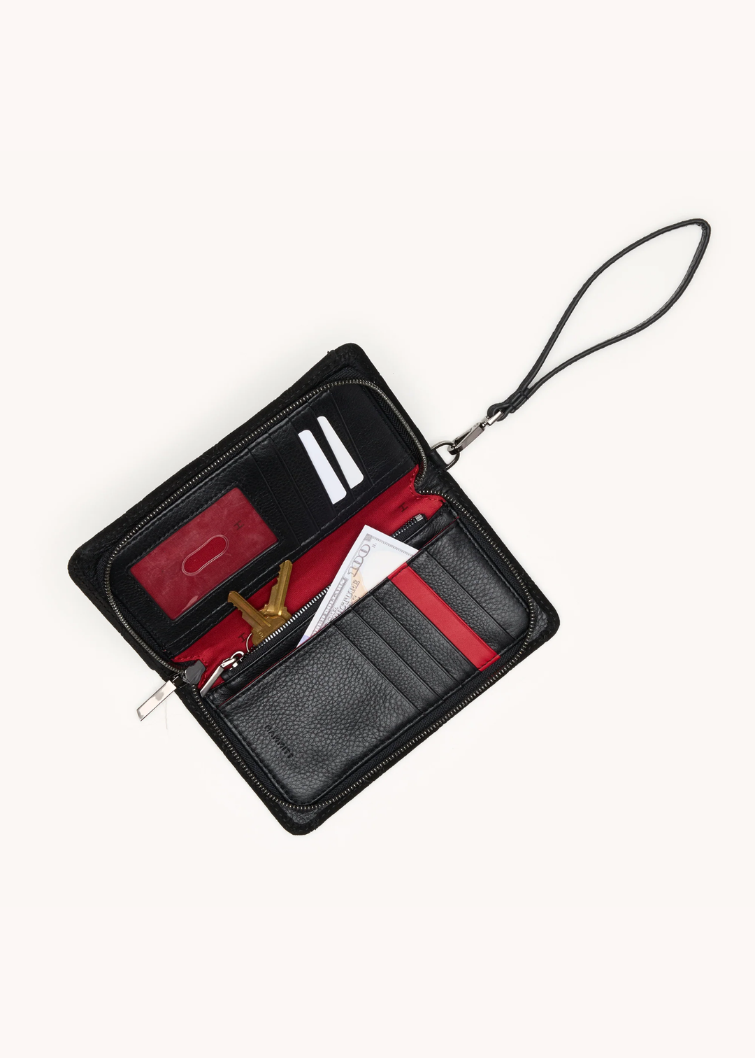 Black suede wallet with red interior on a white background