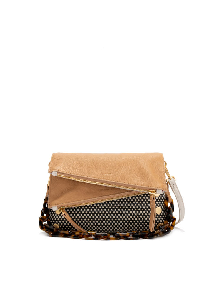 White, tan, and black handbag with gold accents against a white background