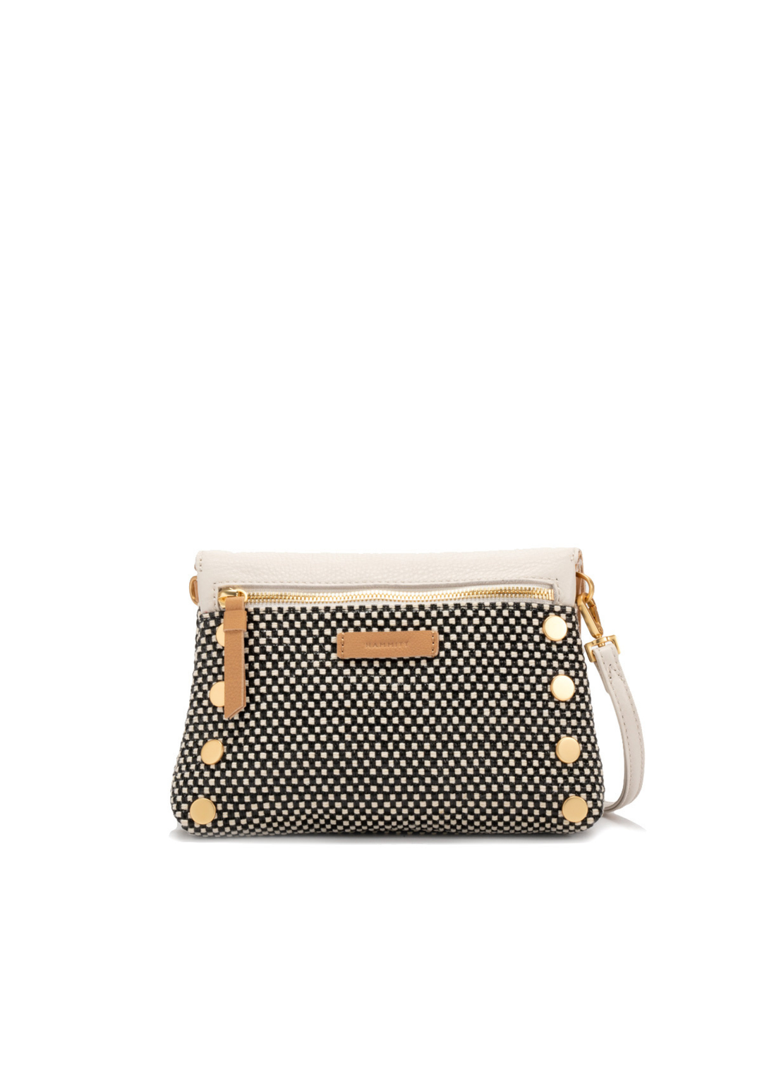 White, tan, and black handbag with gold accents against a white background