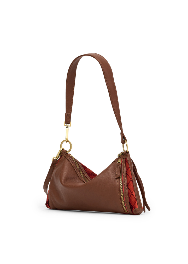 Brown leather handbag with red velvet and gold accents on a white background