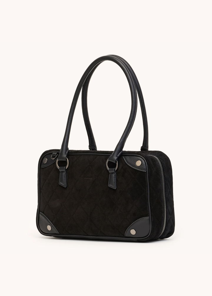 Black suede purse on a white background