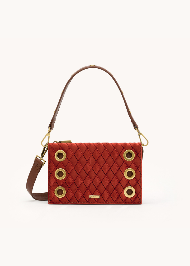 Red velvet handbag with gold and brown leather accents on a white background