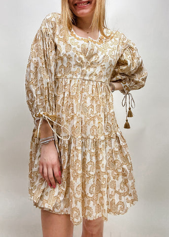 tan and white paisley patterned mini dress with tiered skirt and 3/4 sleeves with tassel ties