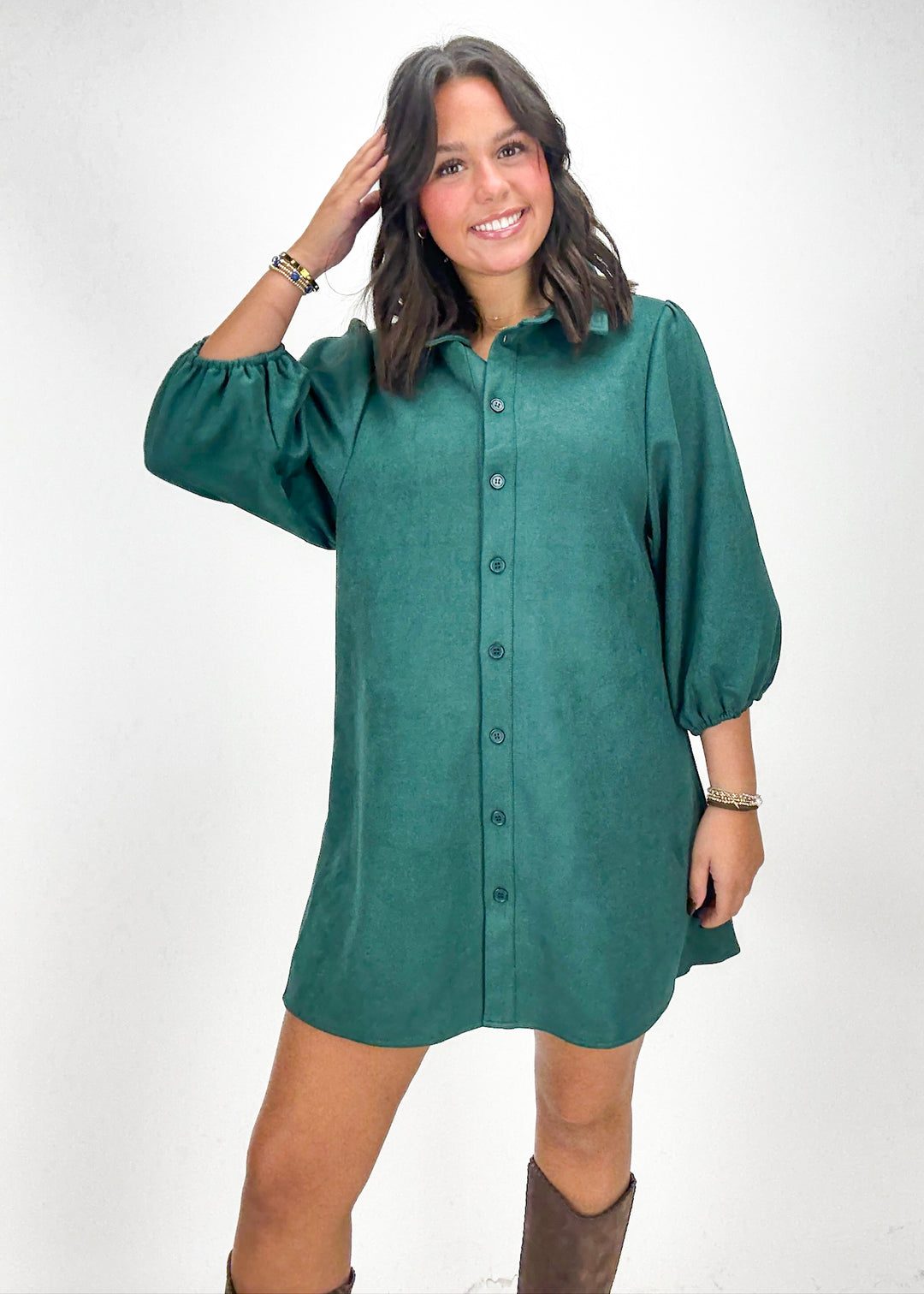 Woman wearing a green dress with puffed sleeves 