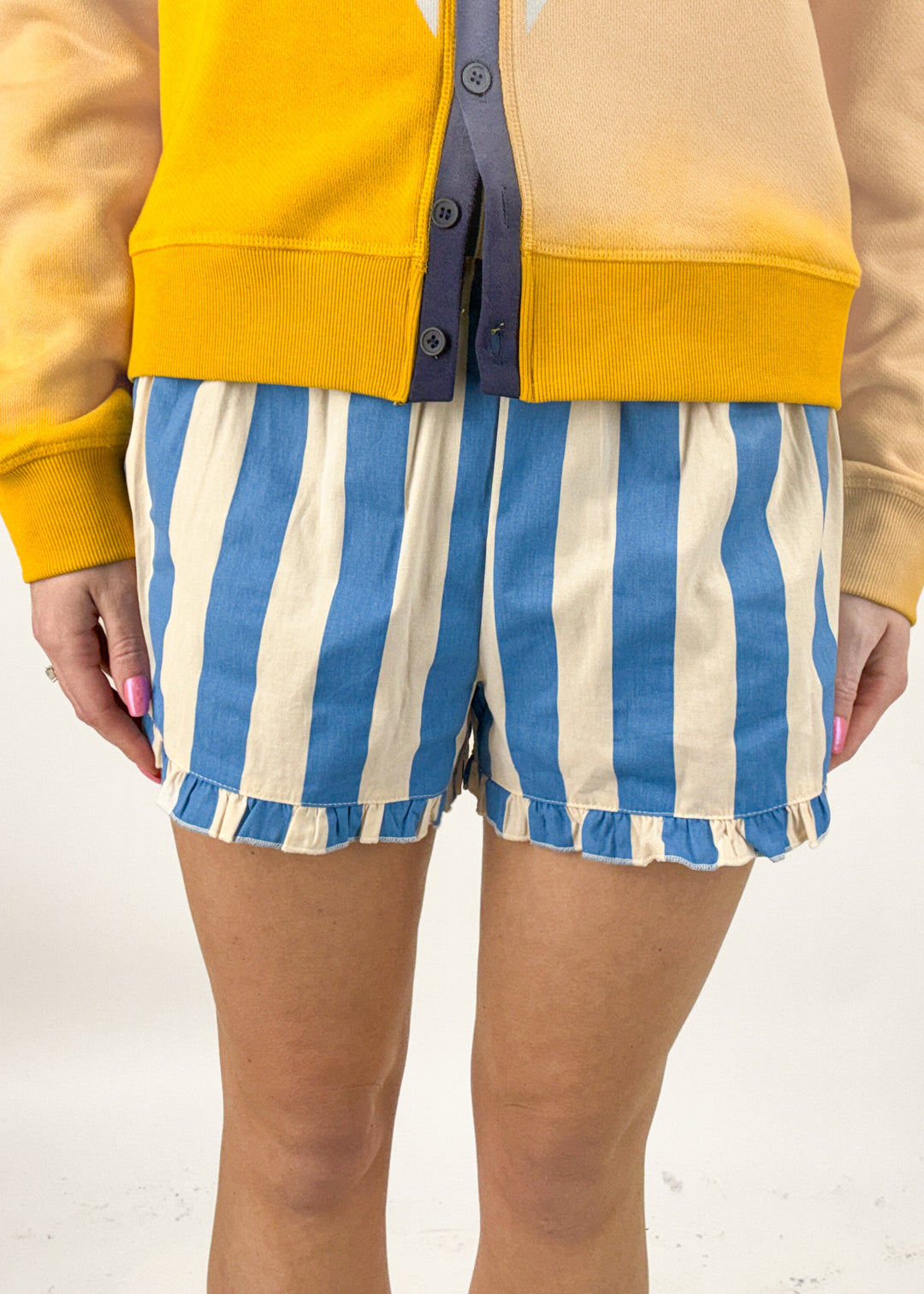 Woman wearing blue and white striped shorts. 