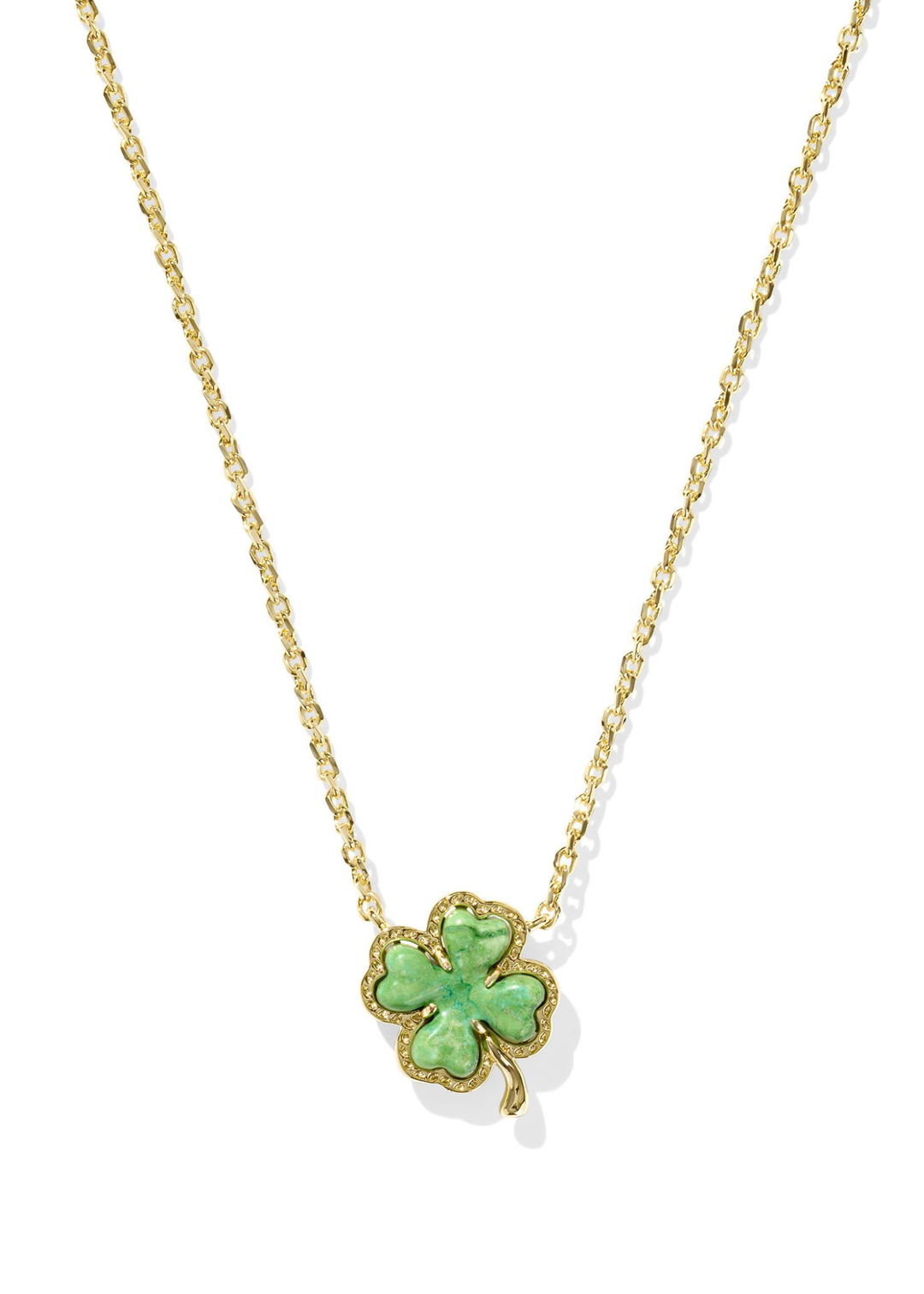Gold necklace with a green clover pendant on a white necklace