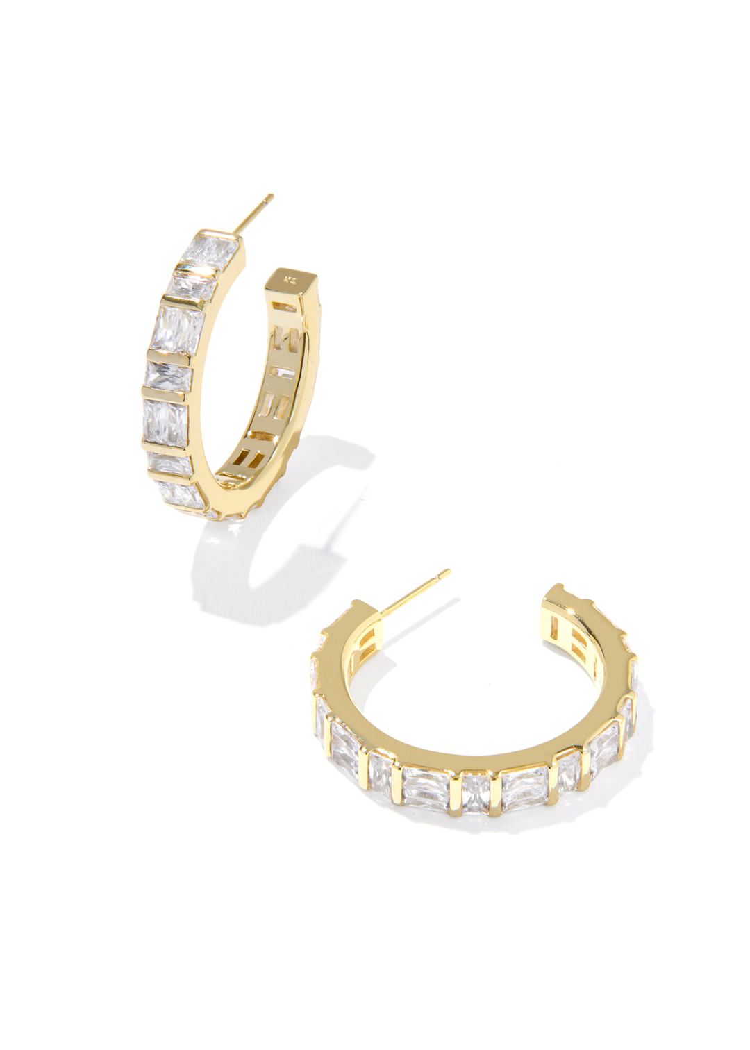 Gold hoop earrings with clear CZ studding on a white background