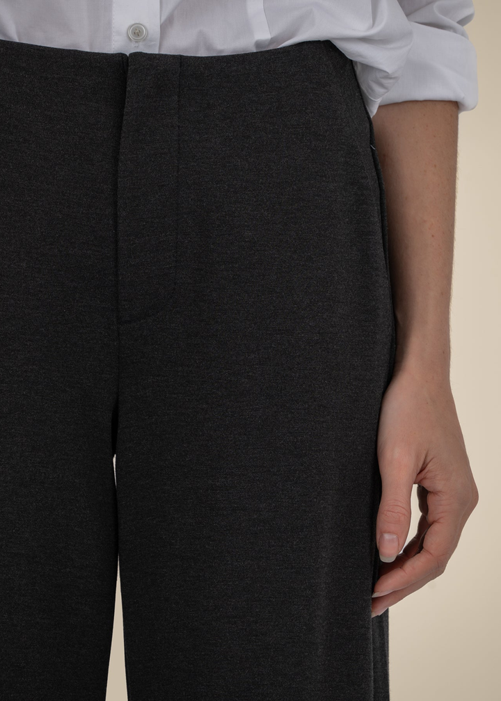 Close up of a woman wearing charcoal grey pants