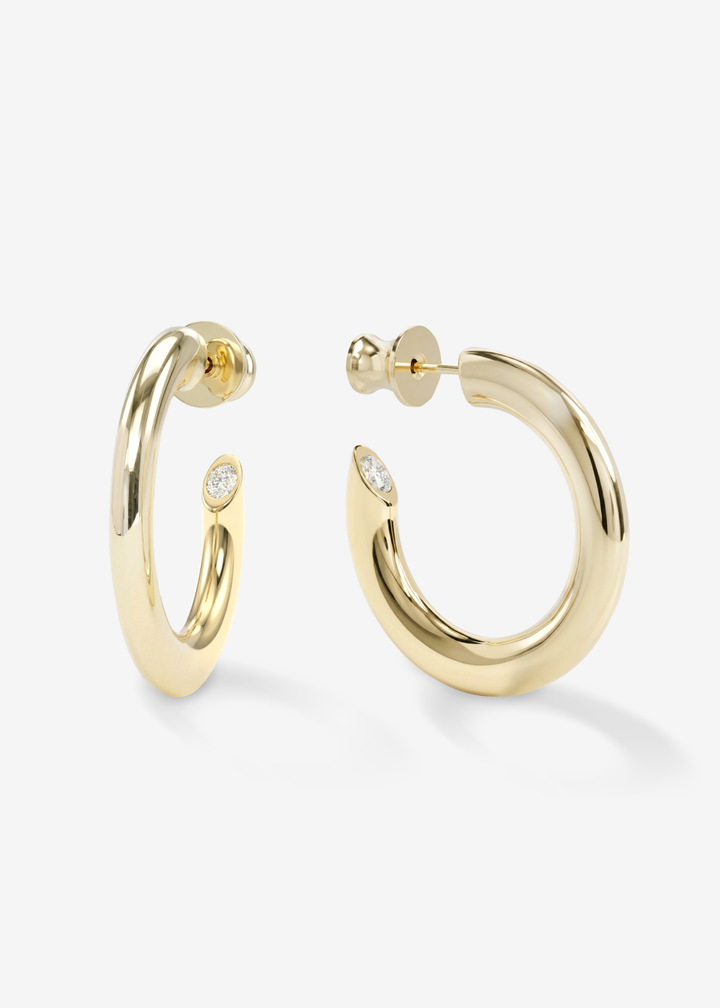 Smooth gold hoop earrings against a white background