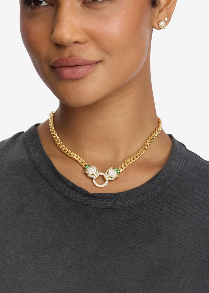 Woman wearing a gold chain necklace with two pave jaguar heads 