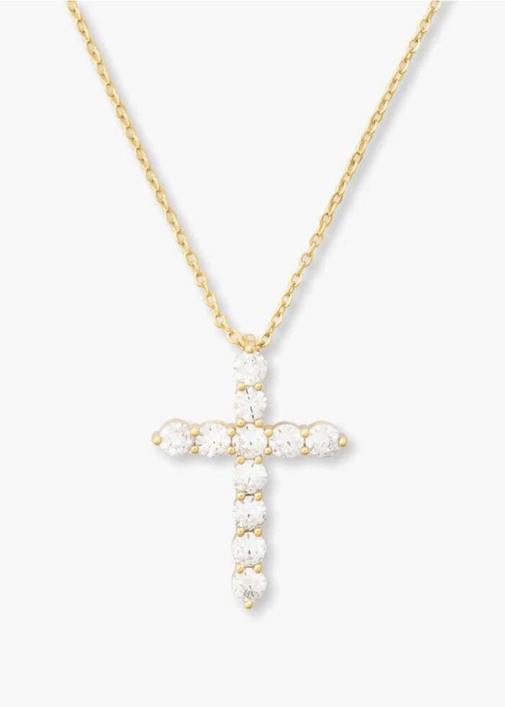 Gold cross pendant necklace with simulated diamonds on a white background