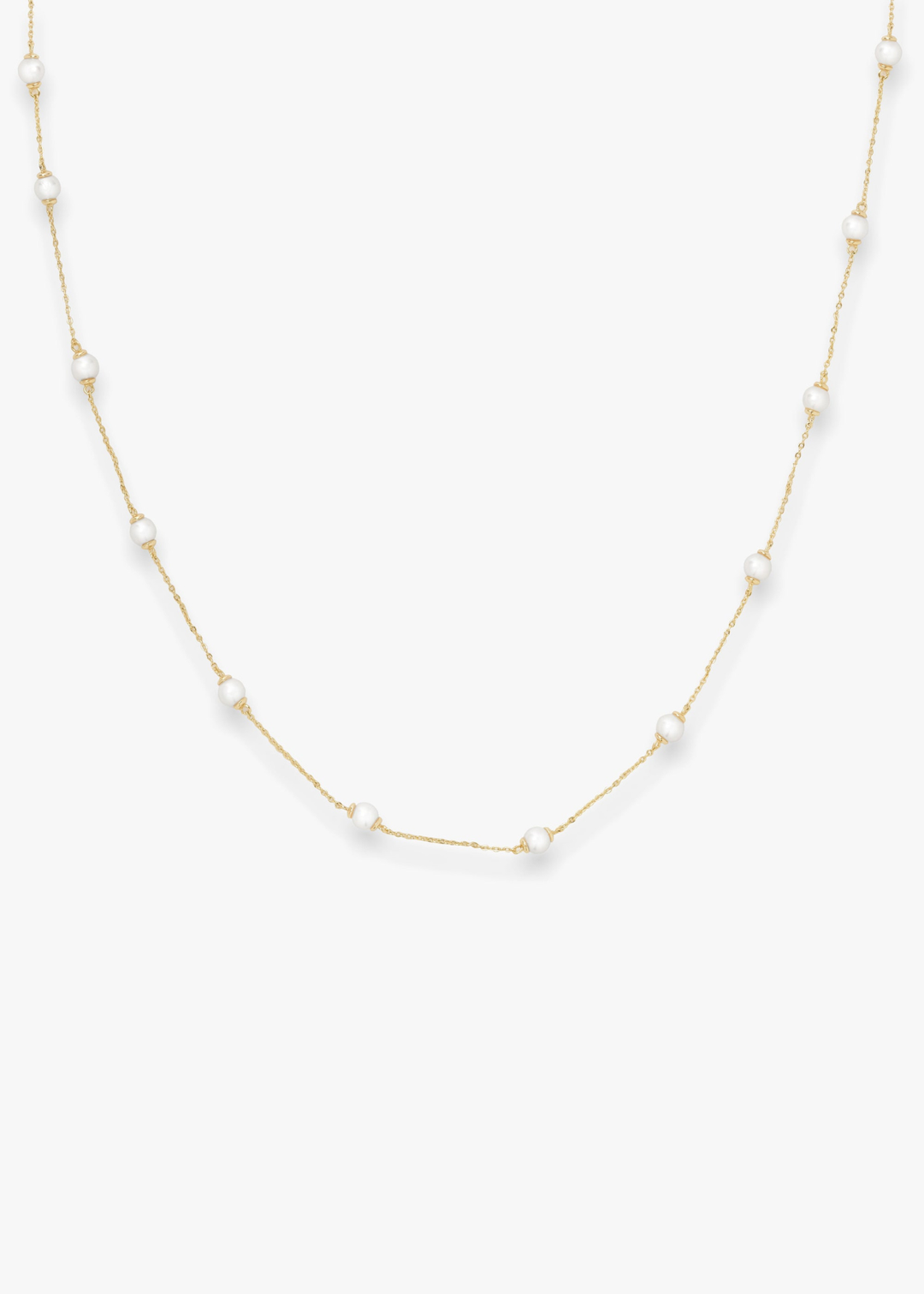Gold pearl strand necklace on a white background