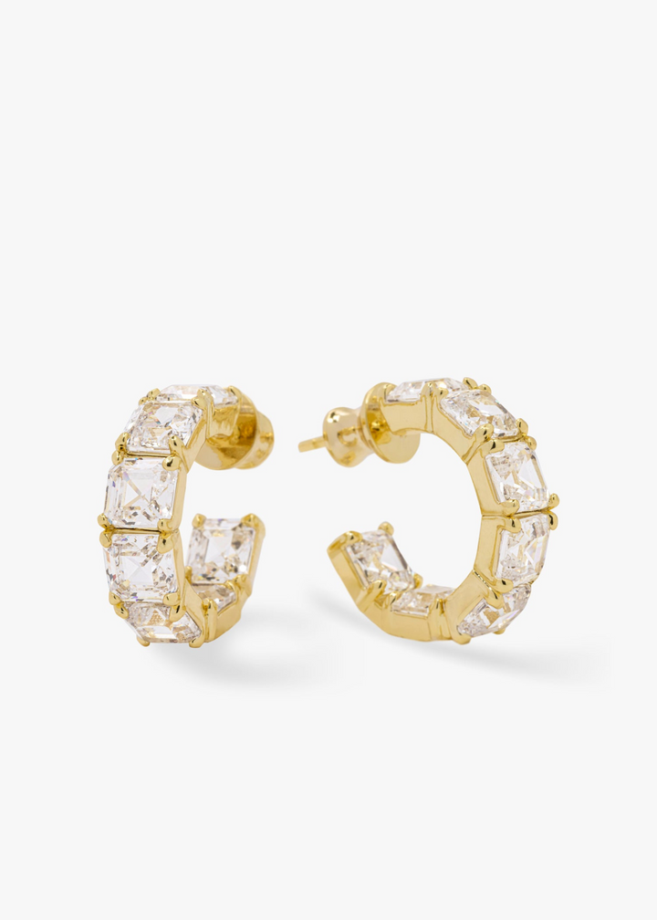 Gold hoop earrings with diamond studs on a white background