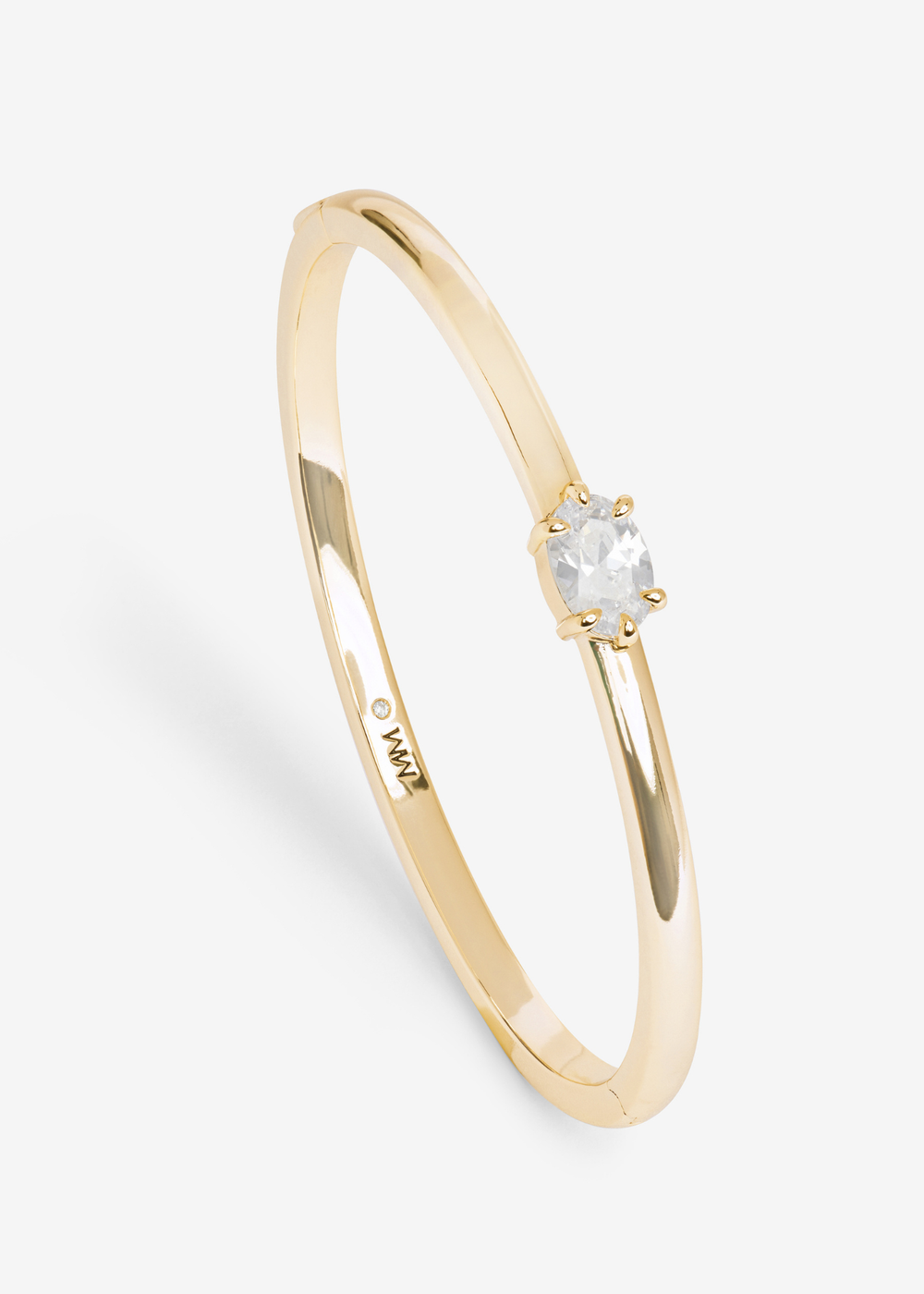 Gold cuff bracelet with a diamond stud on a white background
