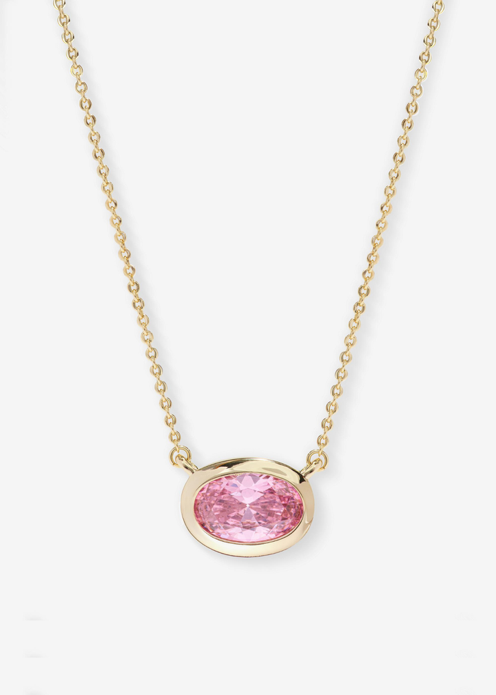 Gold frame necklace with a pink pendant on a white background