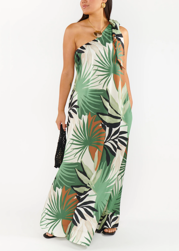 Woman wearing a tropical patterned, one shoulder dress