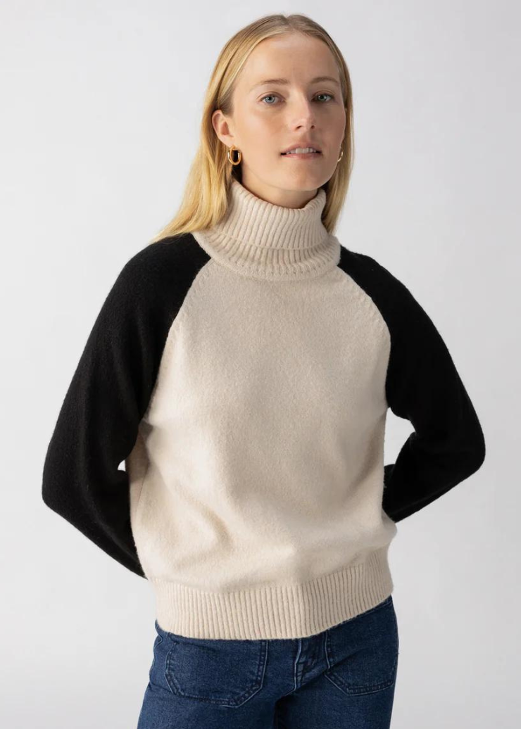 toasted almond turtleneck sweater with black color block sleeves