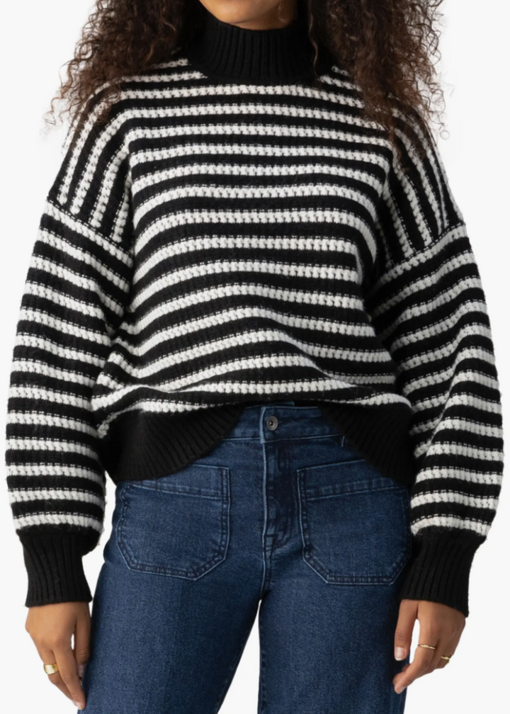 black and white stripe oversized sweater with black mock neck collar, hem, and cuffs