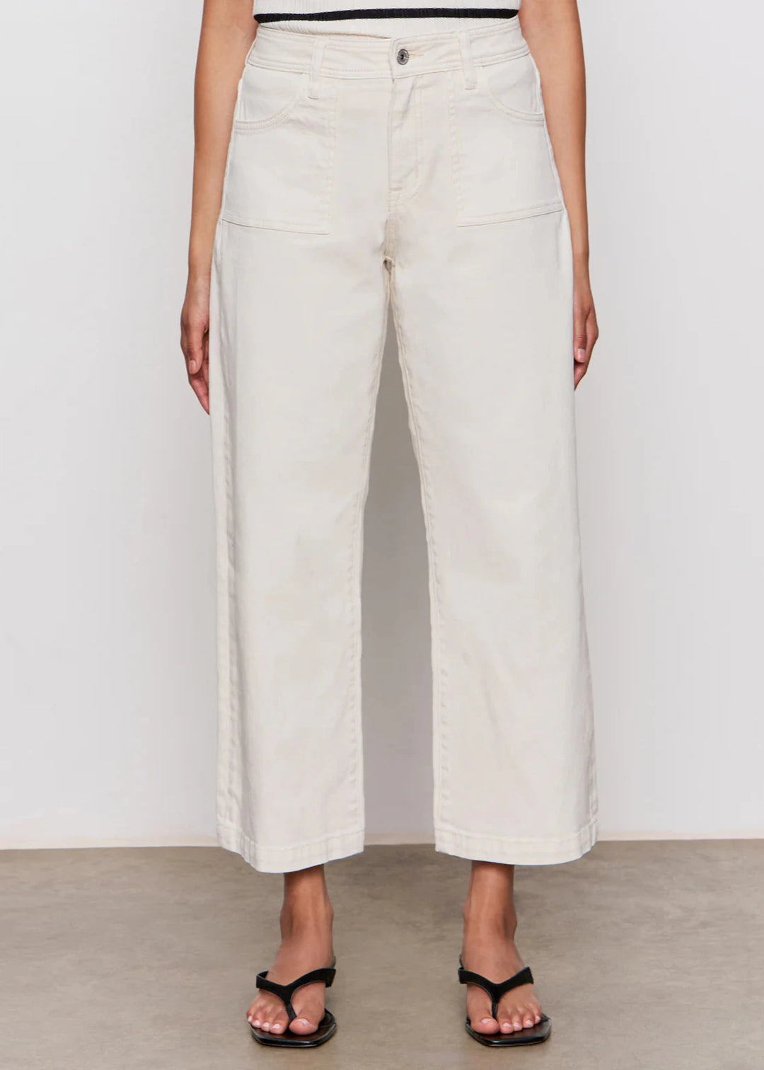 woman wearing off white wide leg denim jeans