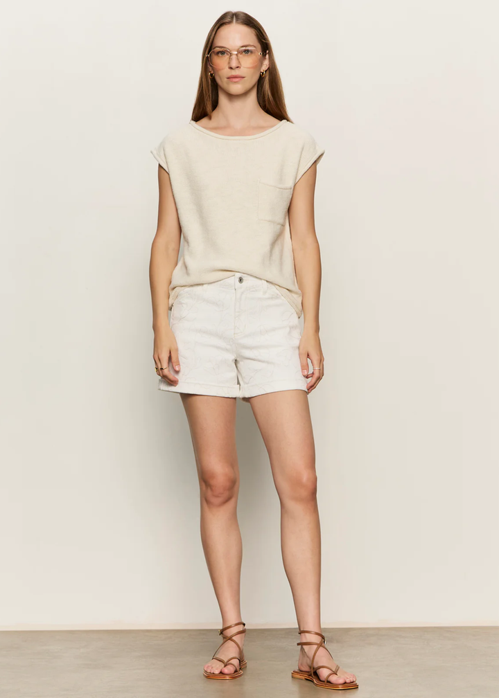 Woman wearing white shorts with a floral pattern