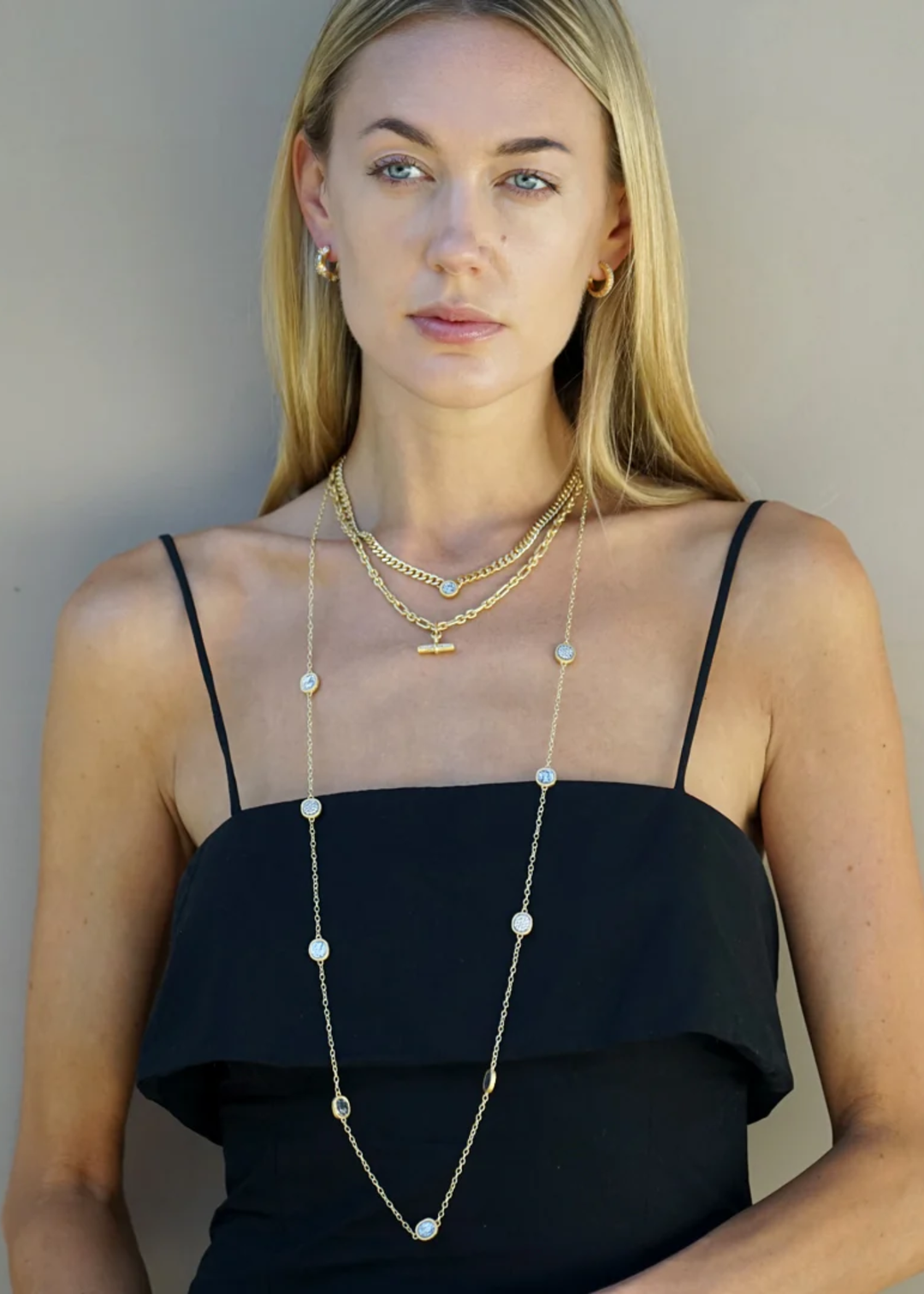 Woman wearing multiple gold layered necklaces