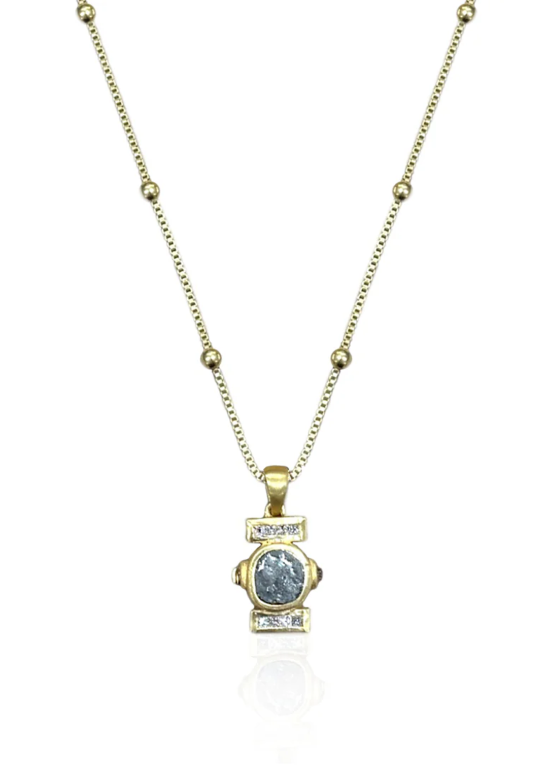 Gold chain necklace with a silver coin pendant surrounded by a gold frame with CZ details on a white background