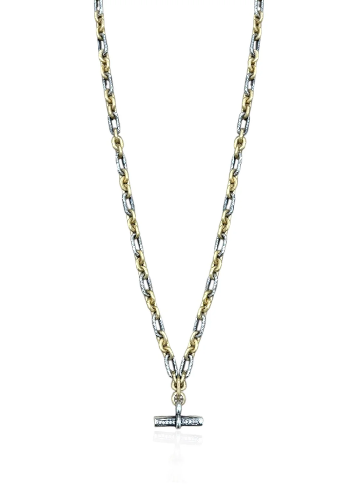 Mixed metal chain necklace with a CZ studded toggle on a white background