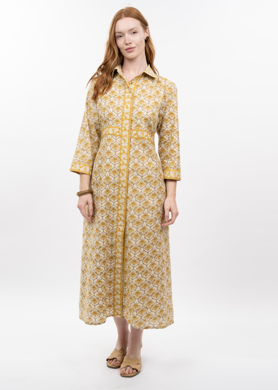 Woman wearing a gold floral print midi dress