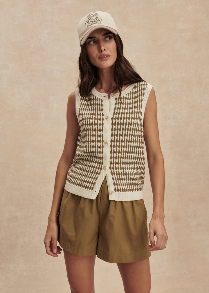 Woman wearing a brown and white knit button up tank top with matching brown shorts