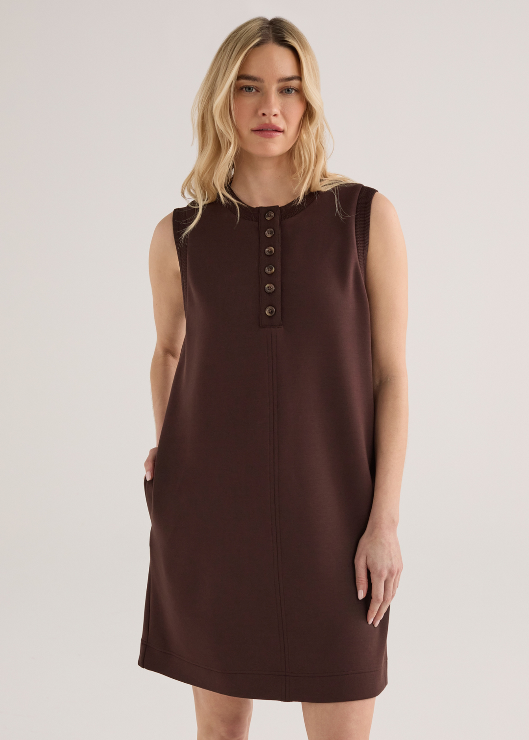 Woman wearing a brown sleeveless mini dress