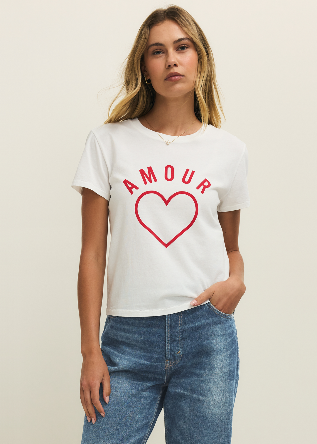 Woman wearing a white t-shirt with a red heart and "AMOUR" lettering