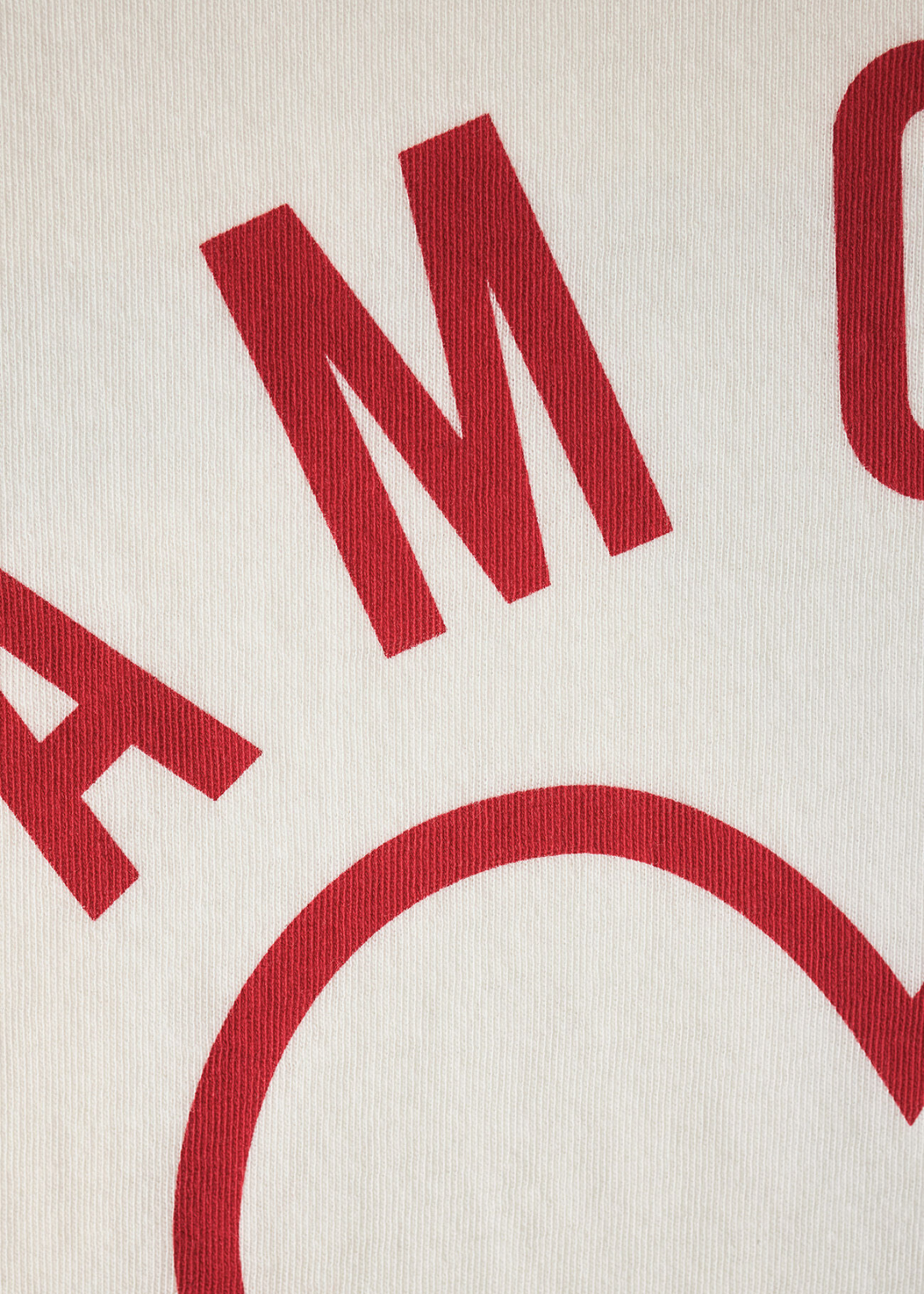 Close up of a white shirt with a red heart and "AMOUR" graphic