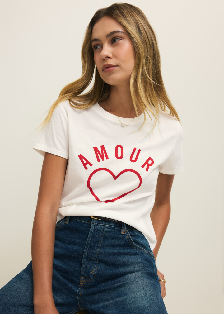 Woman wearing a white t-shirt with a red heart and "AMOUR" lettering